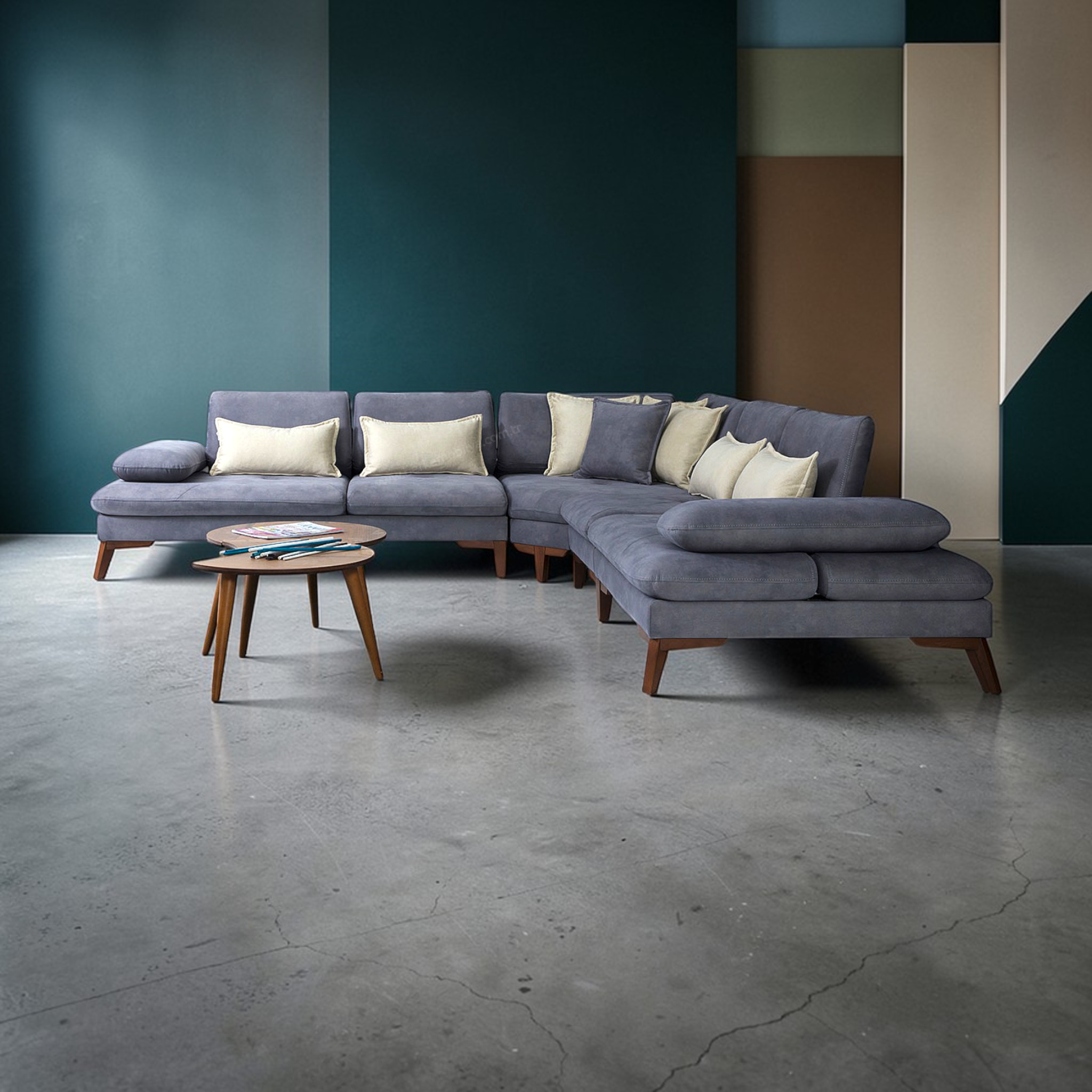 Gray sectional sofa with wooden legs in a room with a geometric wall design.