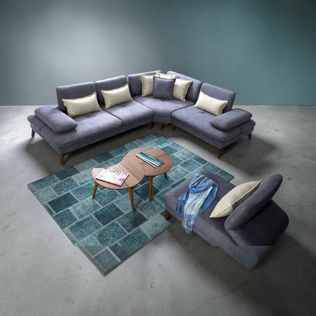 Gray sectional sofa with cushions in a modern living room setting.