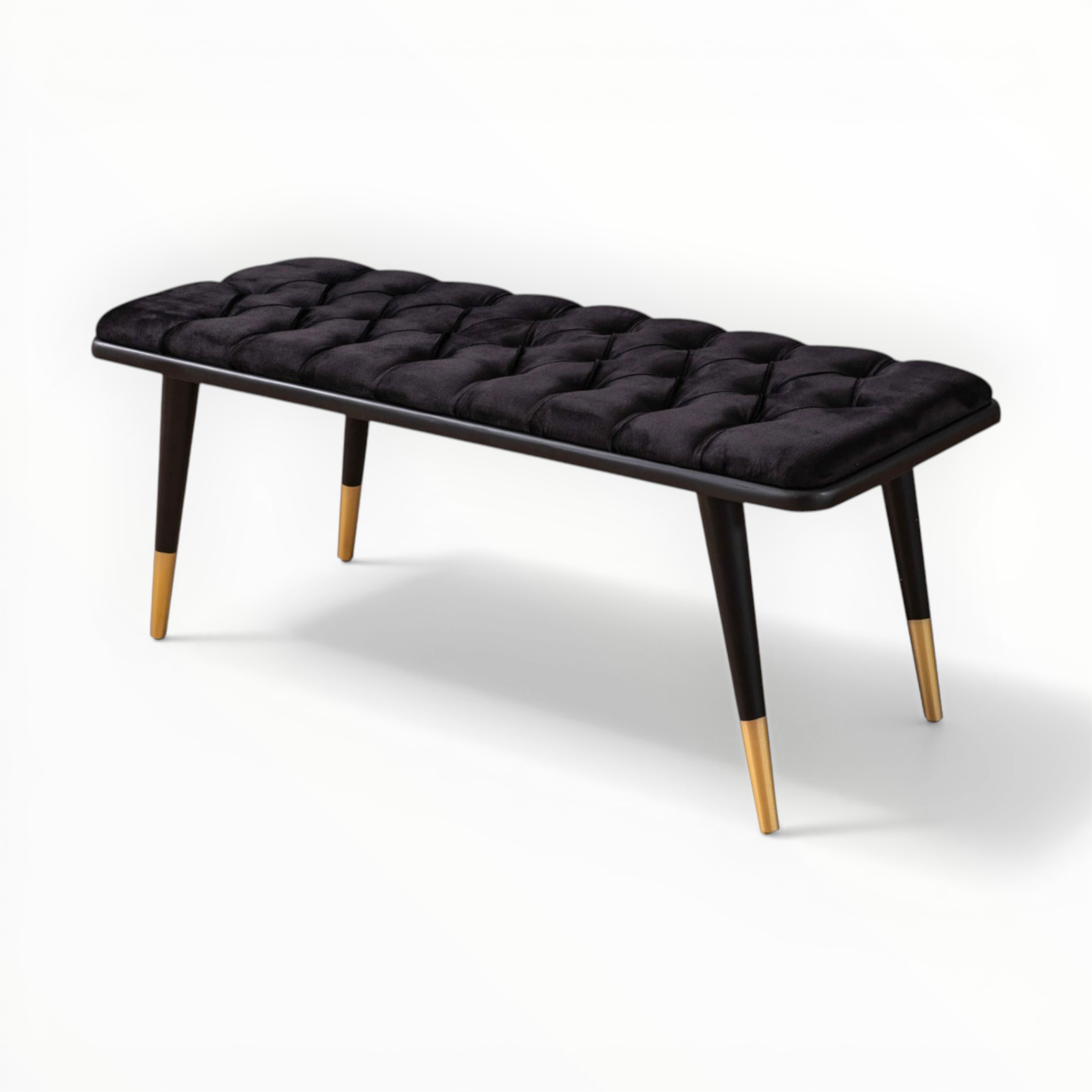 Black tufted bench with gold accents on a white background