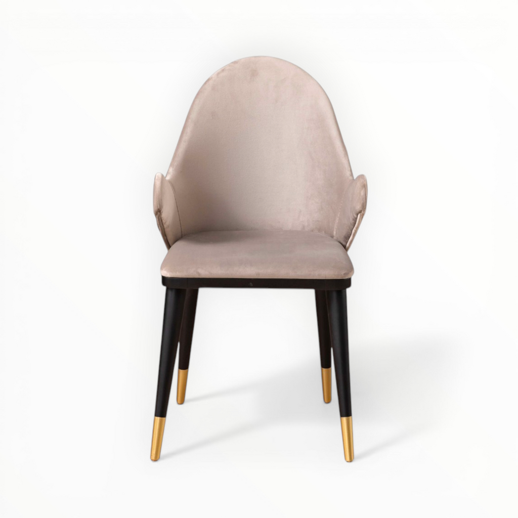 Beige chair with black legs and gold tips on a white background