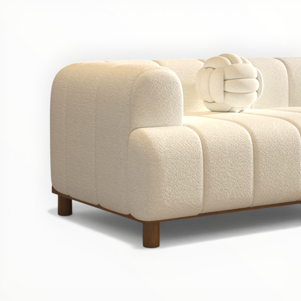 Beige sofa with wooden legs on a white background