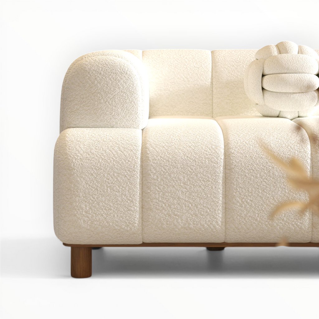 Beige sofa with wooden legs on a white background