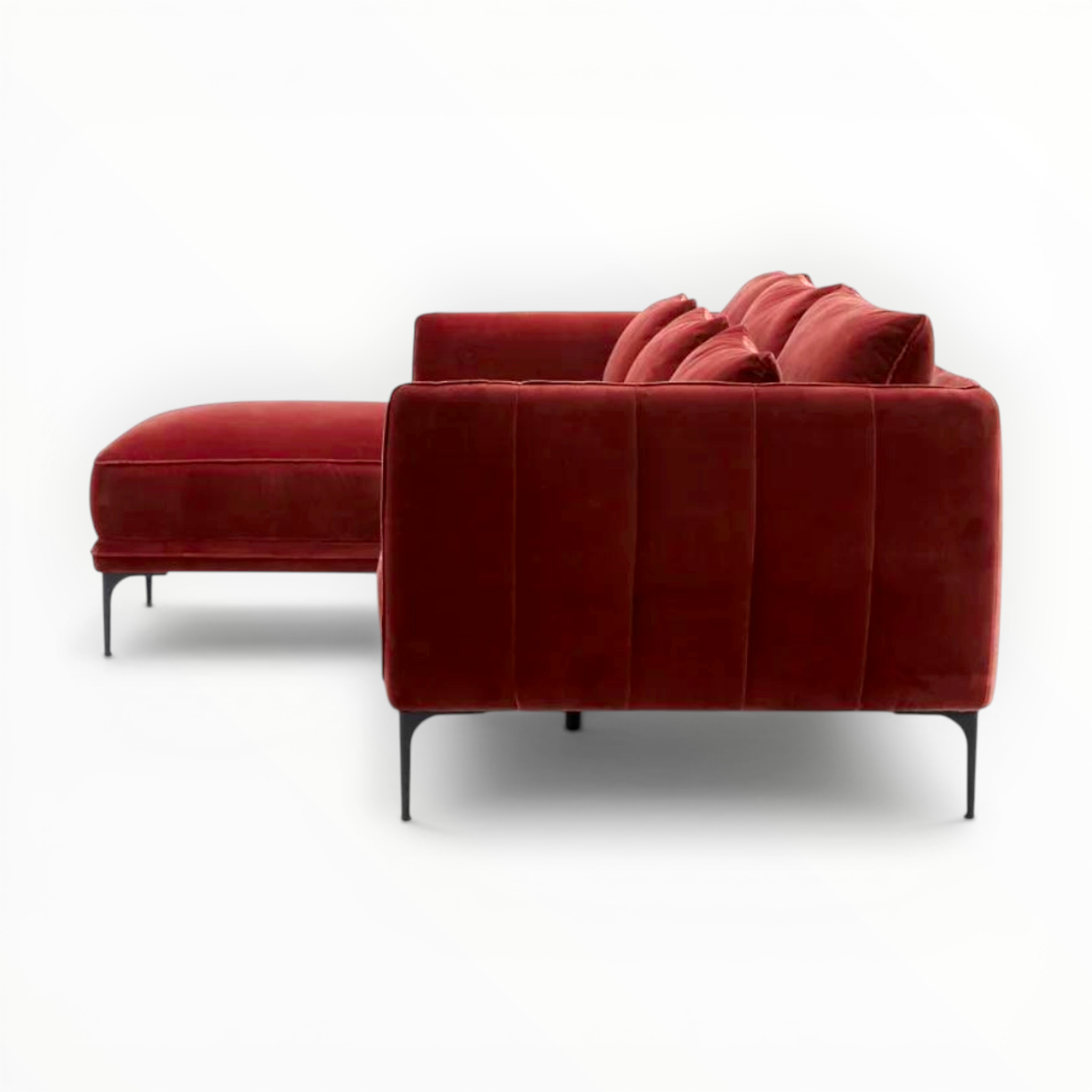 Red velvet sofa with a matching ottoman on a white background