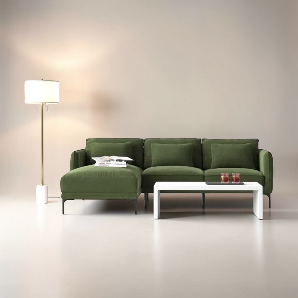 Green sofa in a modern living room with a floor lamp and coffee table.