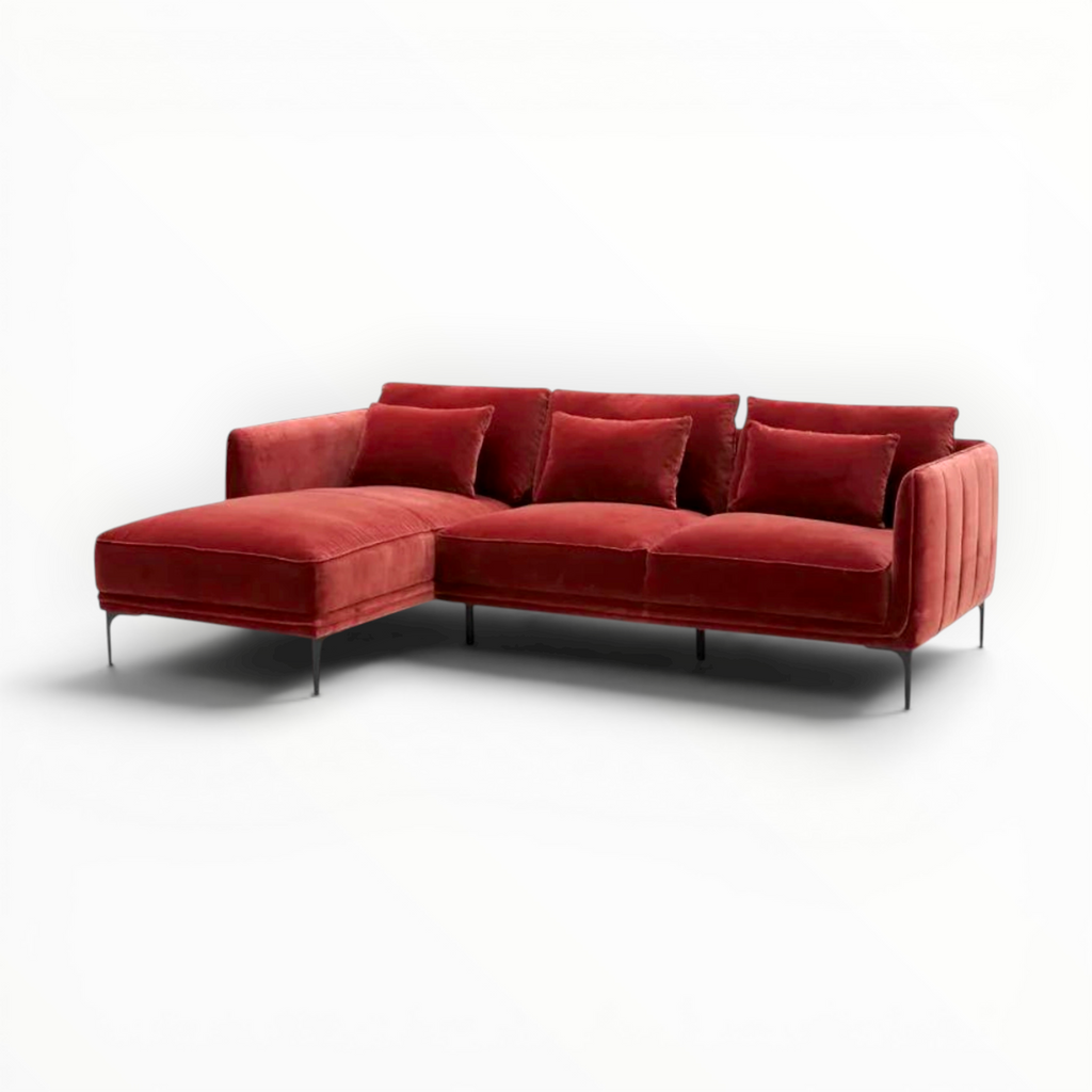 Red sectional sofa with cushions on a white background