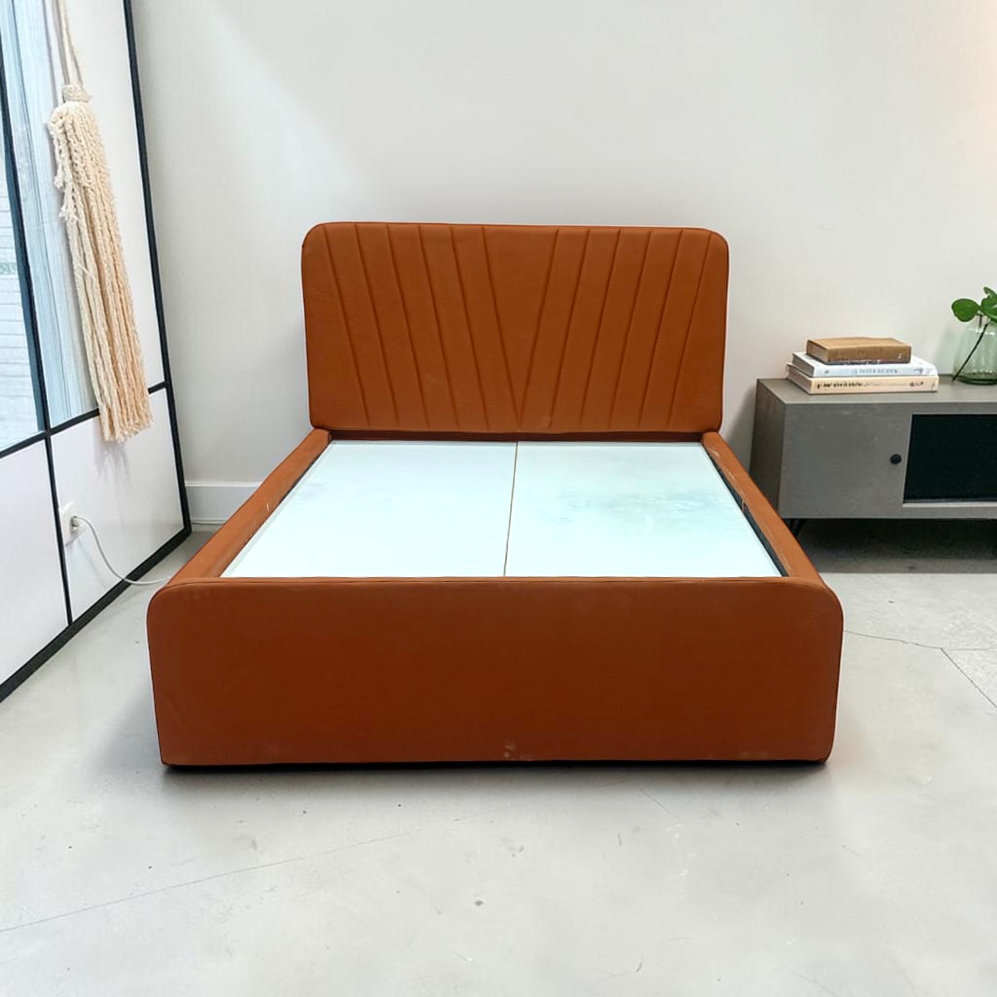 Front view of Reva rust velvet bed with solid platform base and rounded corners, 5x6 ft queen size, Woodkraft Studio Hyderabad