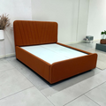 Reva upholstered queen bed in rust velvet with fan-channel V-pattern tufted headboard, handcrafted in Hyderabad