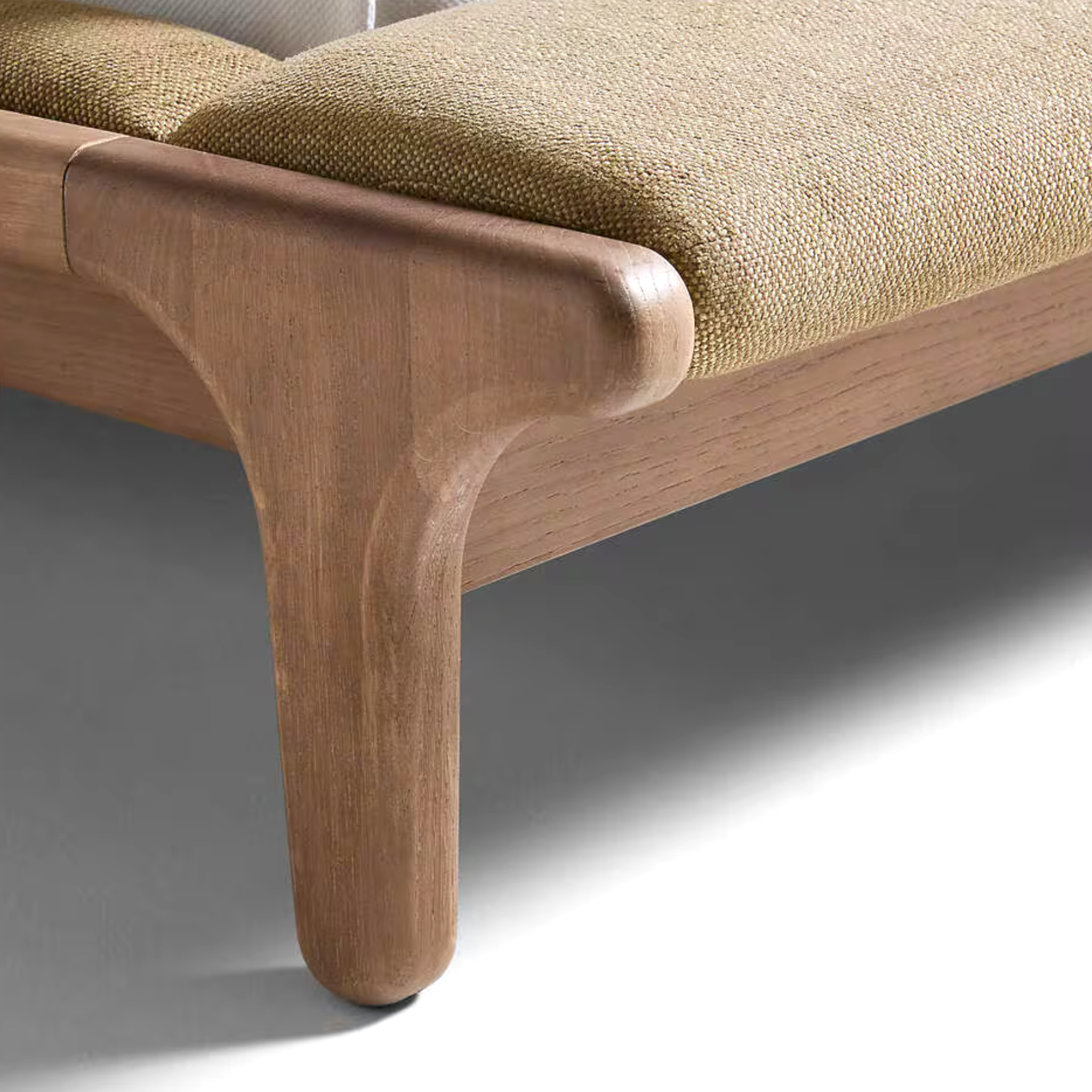 Close-up of a wooden chair with a textured cushion on a neutral background