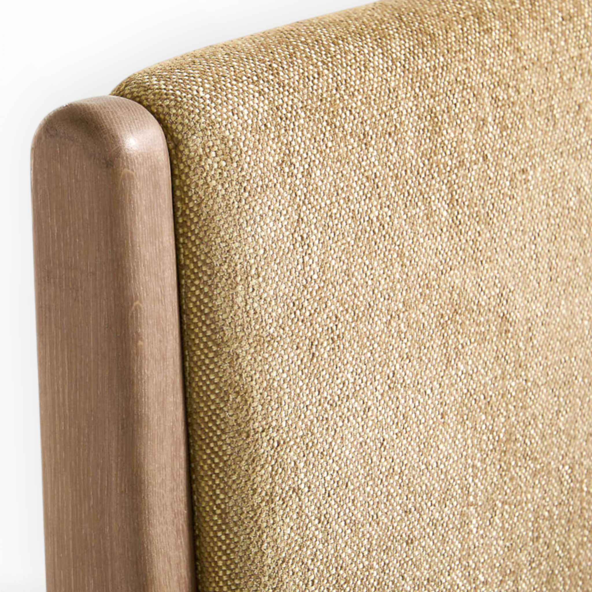 Close-up of a textured beige fabric surface with a wooden headboard.