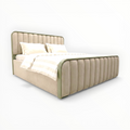 Beige upholstered bed with white bedding on a white background