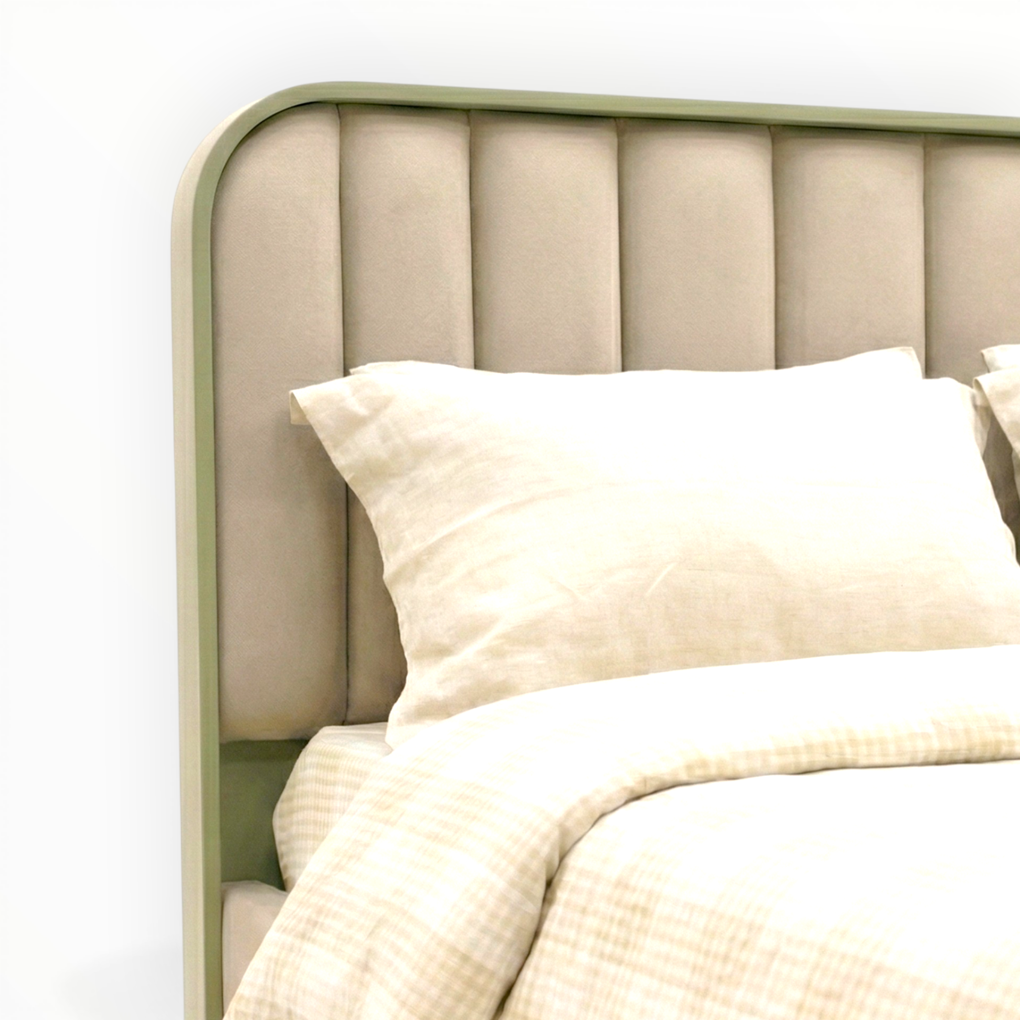 Beige upholstered headboard with white pillows and bedding on a white background