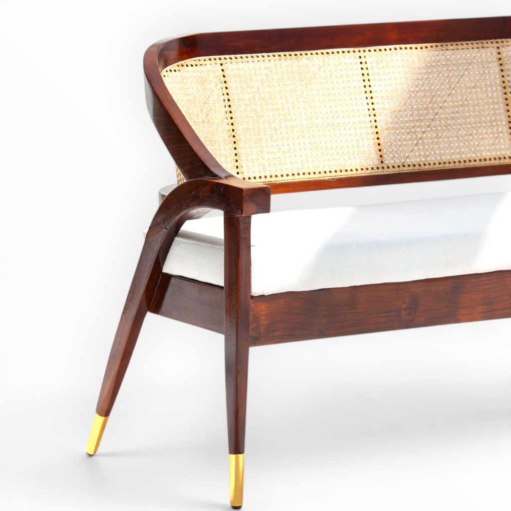 Wooden bench with wicker seat and gold legs on a white background