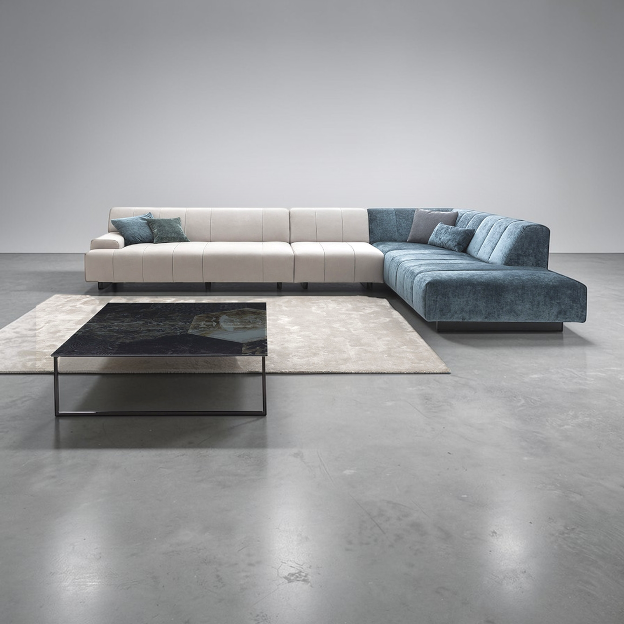 Modern sectional sofa with a coffee table in a minimalistic room.