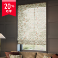 Floral patterned roller blind in a room with a sofa and lamp, featuring a 20% off label.