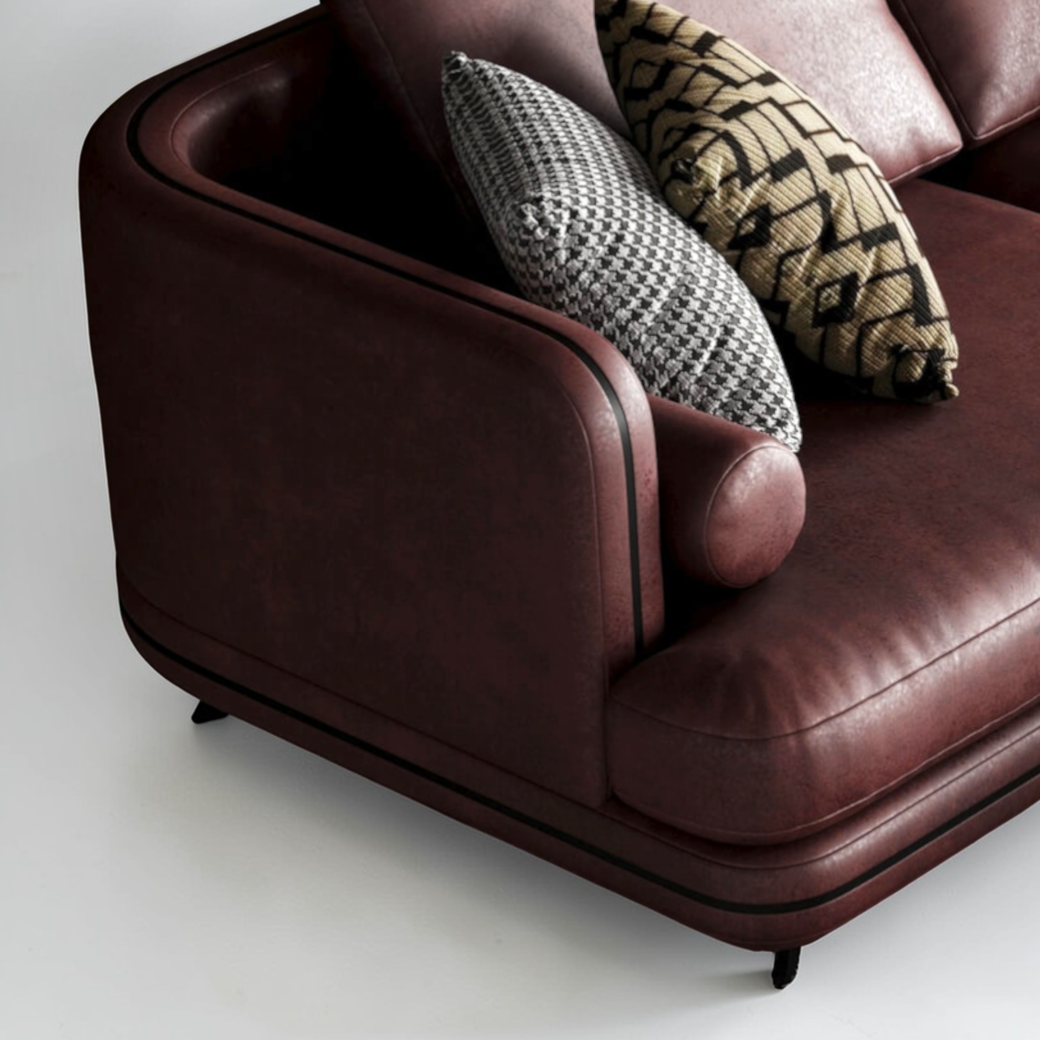 Brown leather armchair with patterned cushions on a white background