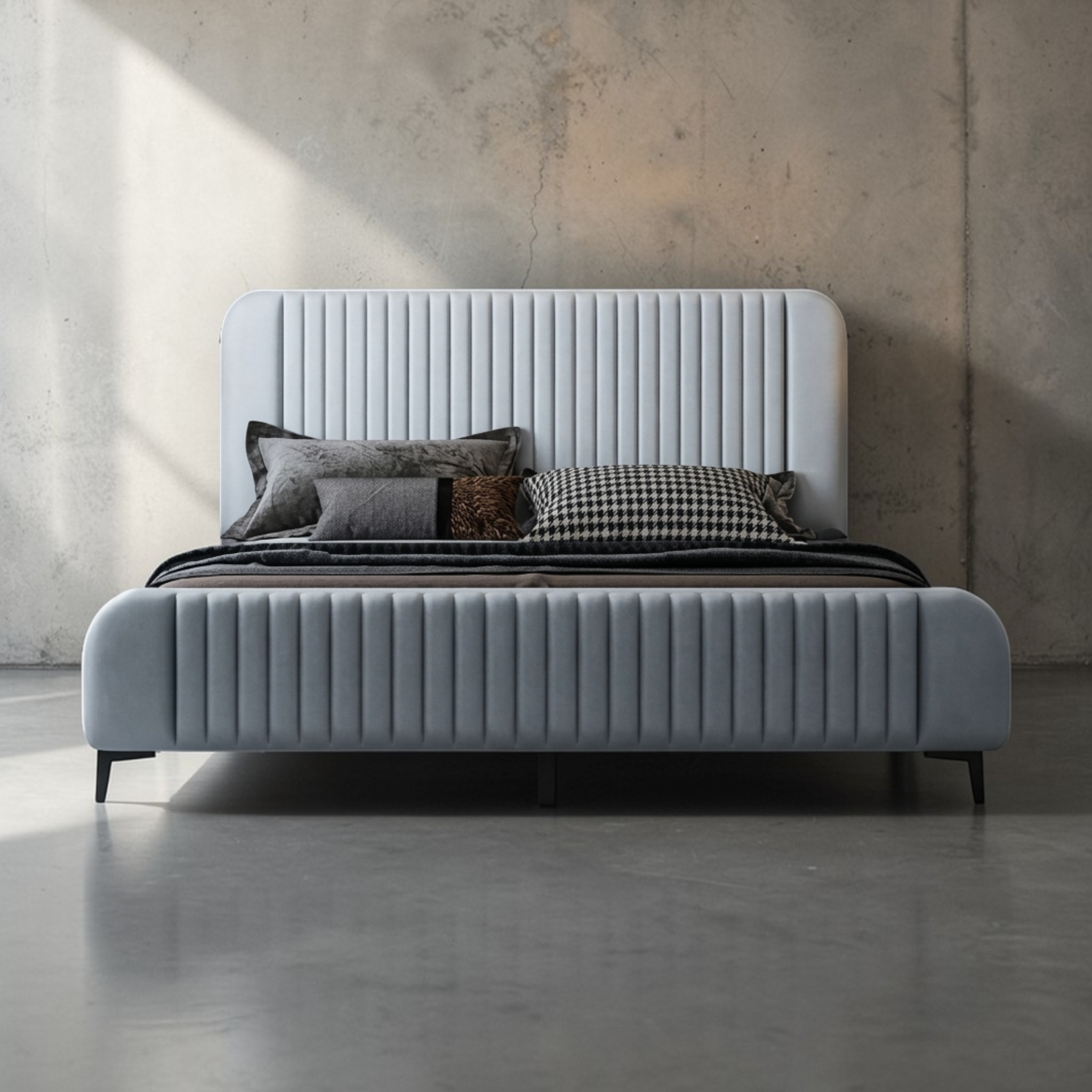 Gray upholstered bed with pillows against a textured wall.