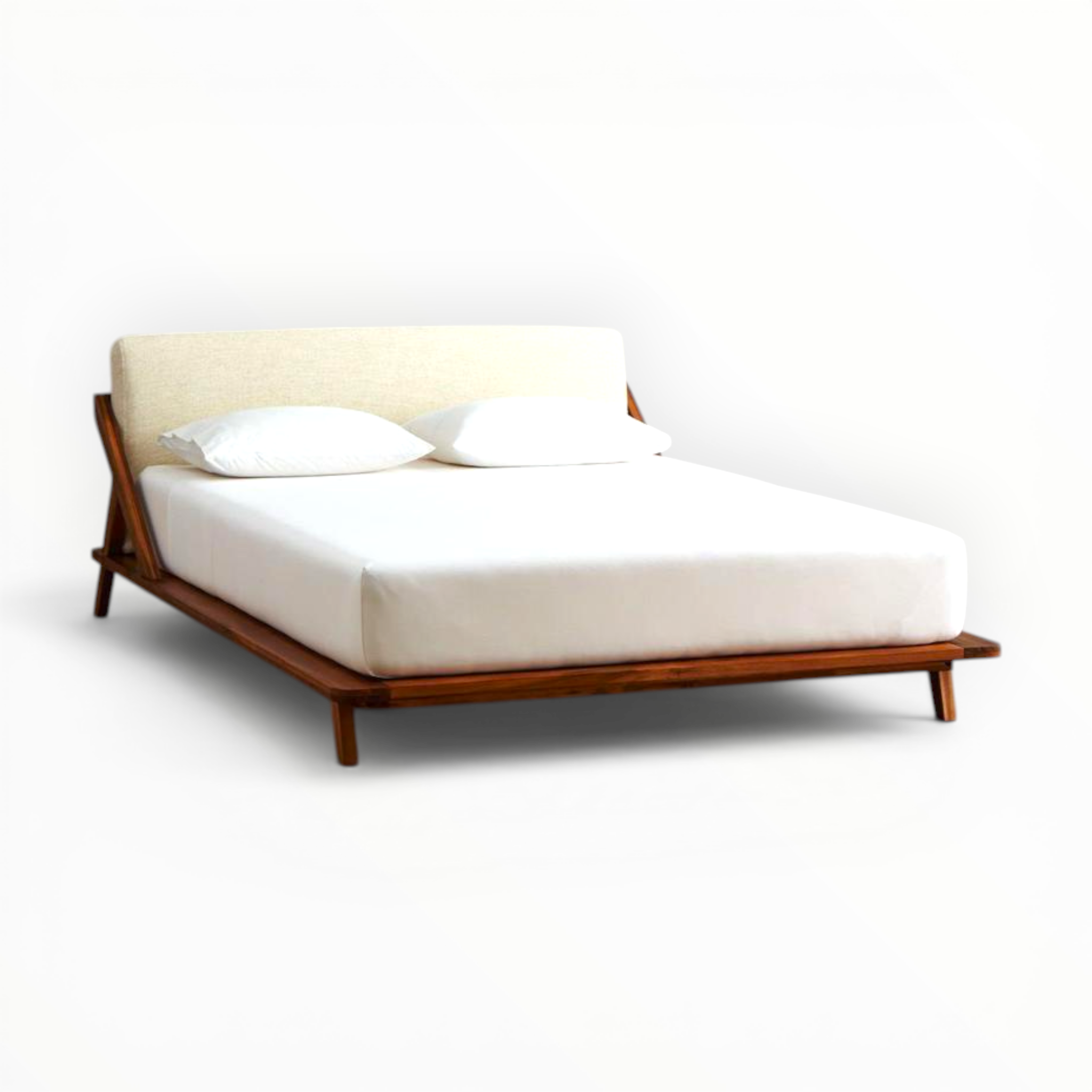 Modern bed with wooden frame and white bedding on a white background