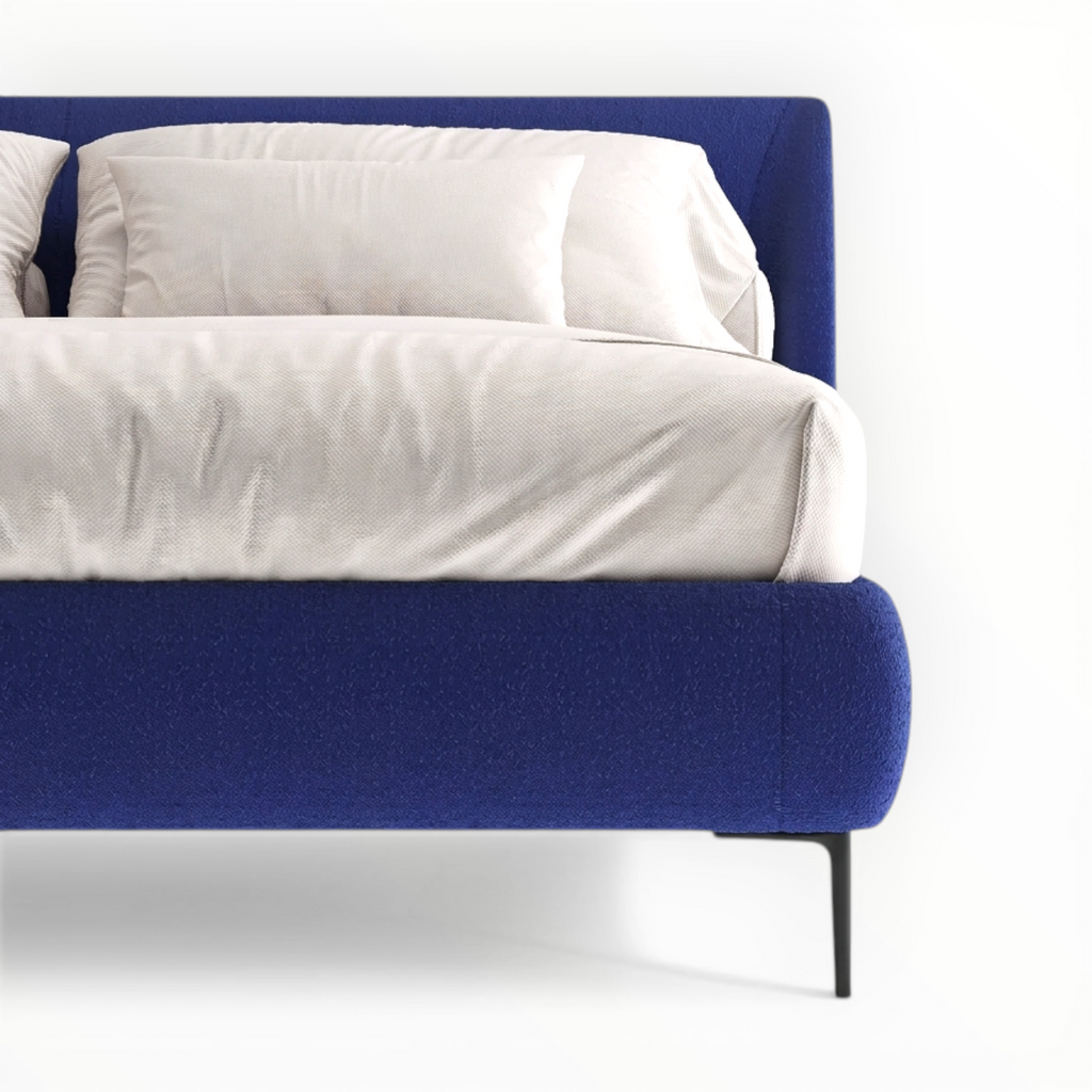 Blue bed frame with white bedding on a white background
