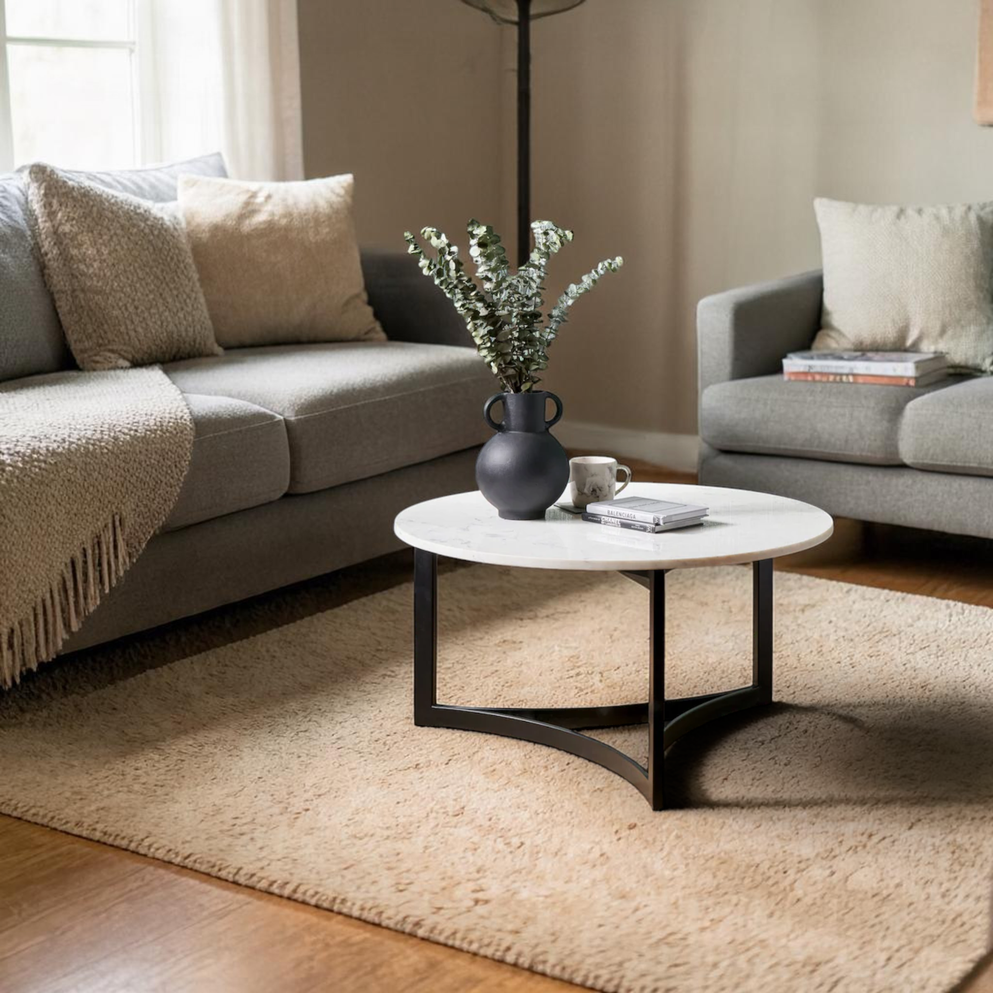 Living room with gray sofa, coffee table, and decorative items.