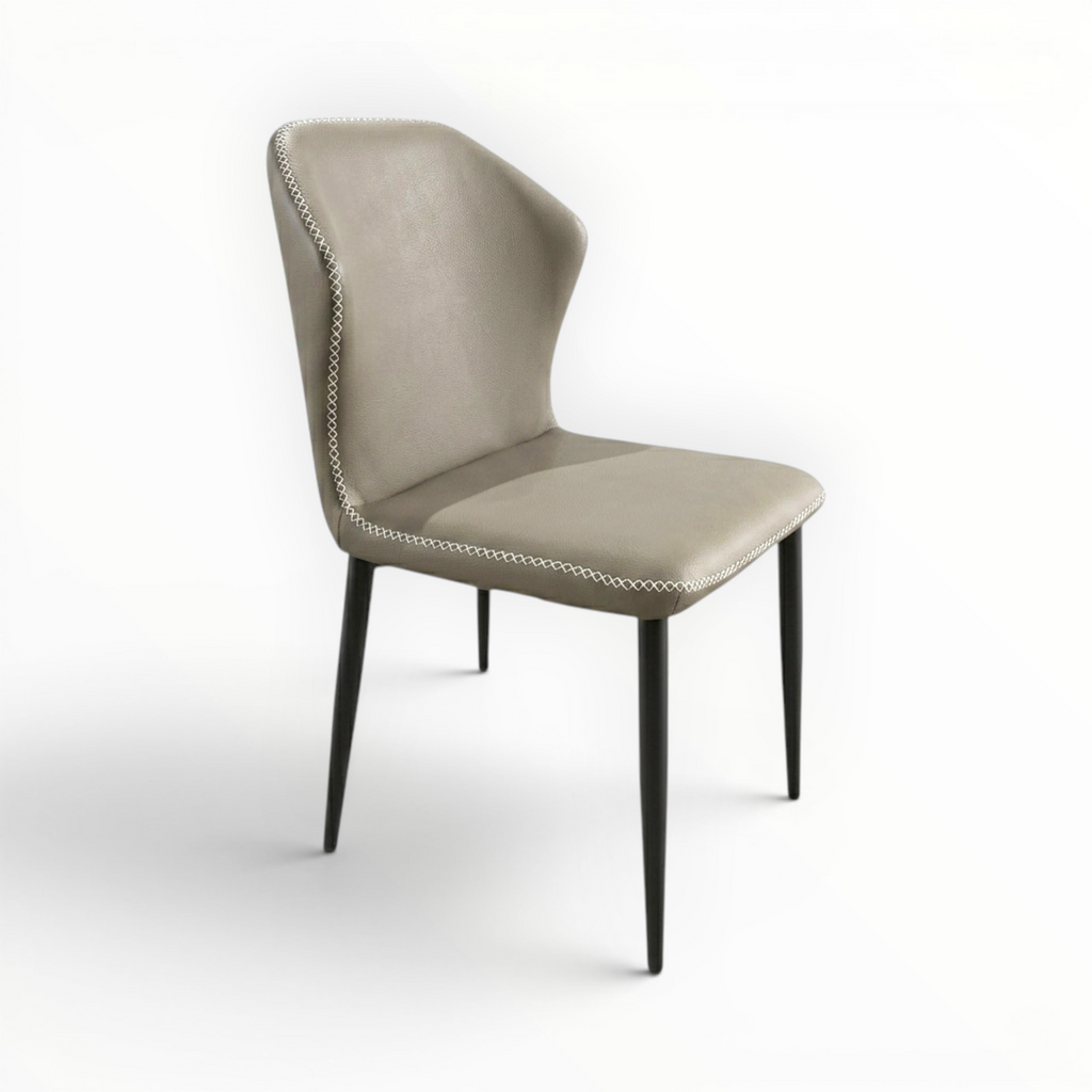 Urban leatherette dining chair – taupe wingback silhouette with contrast cross-stitch border – 3/4 front view