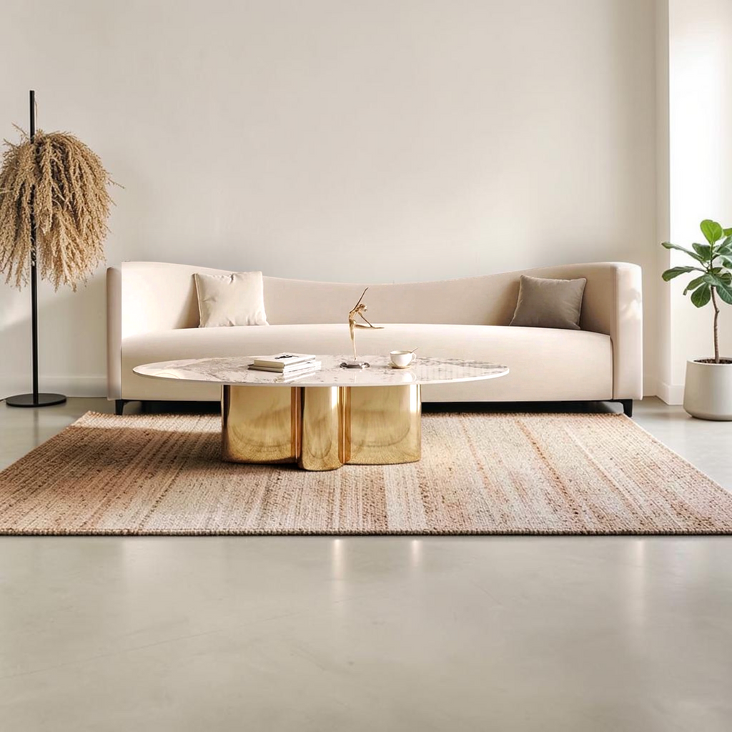 Verona oval marble top gold cylinder base coffee table styled in modern living room with cream sofa and jute rug – Woodkraft Studio Hyderabad