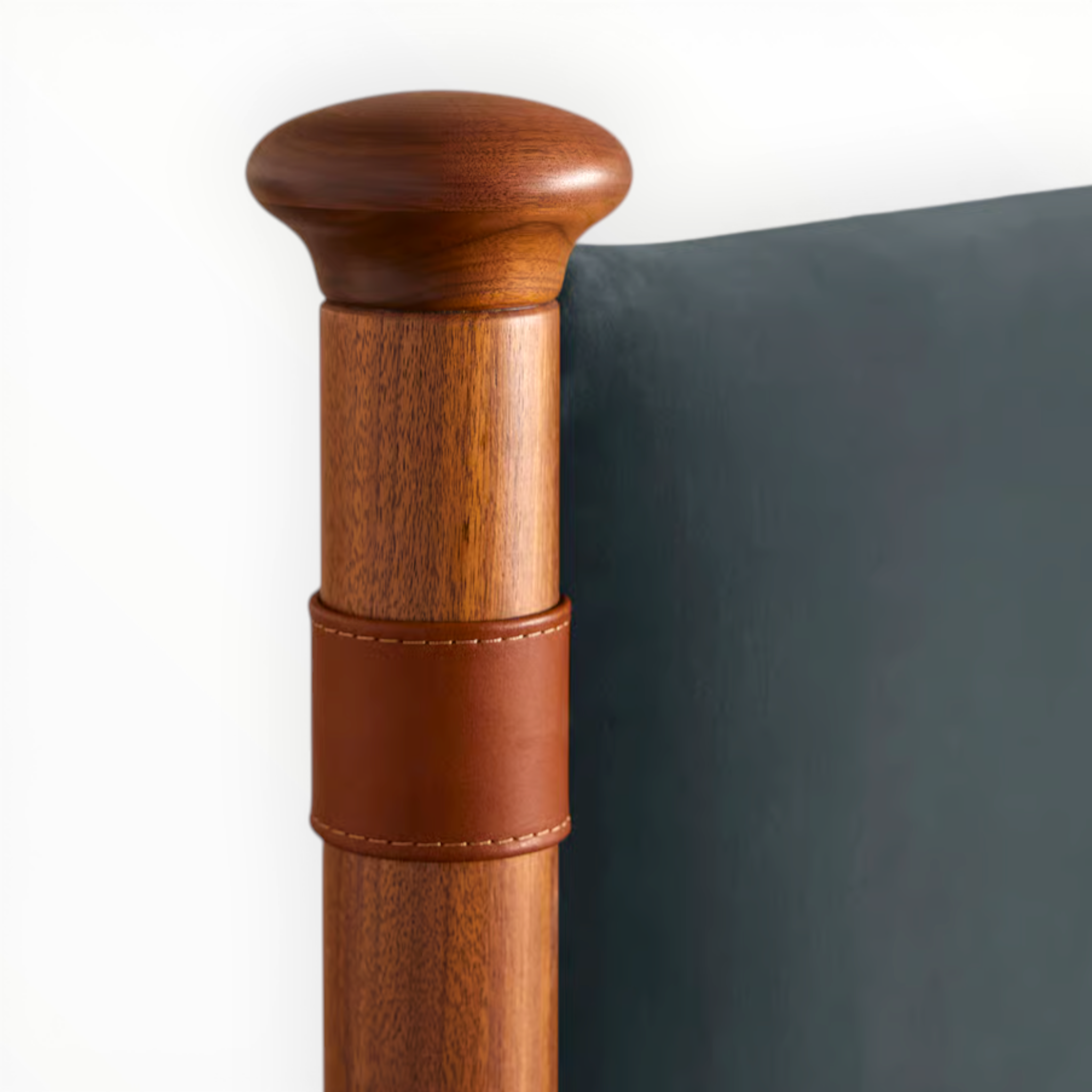 Wooden walking stick with leather wrap on a white background