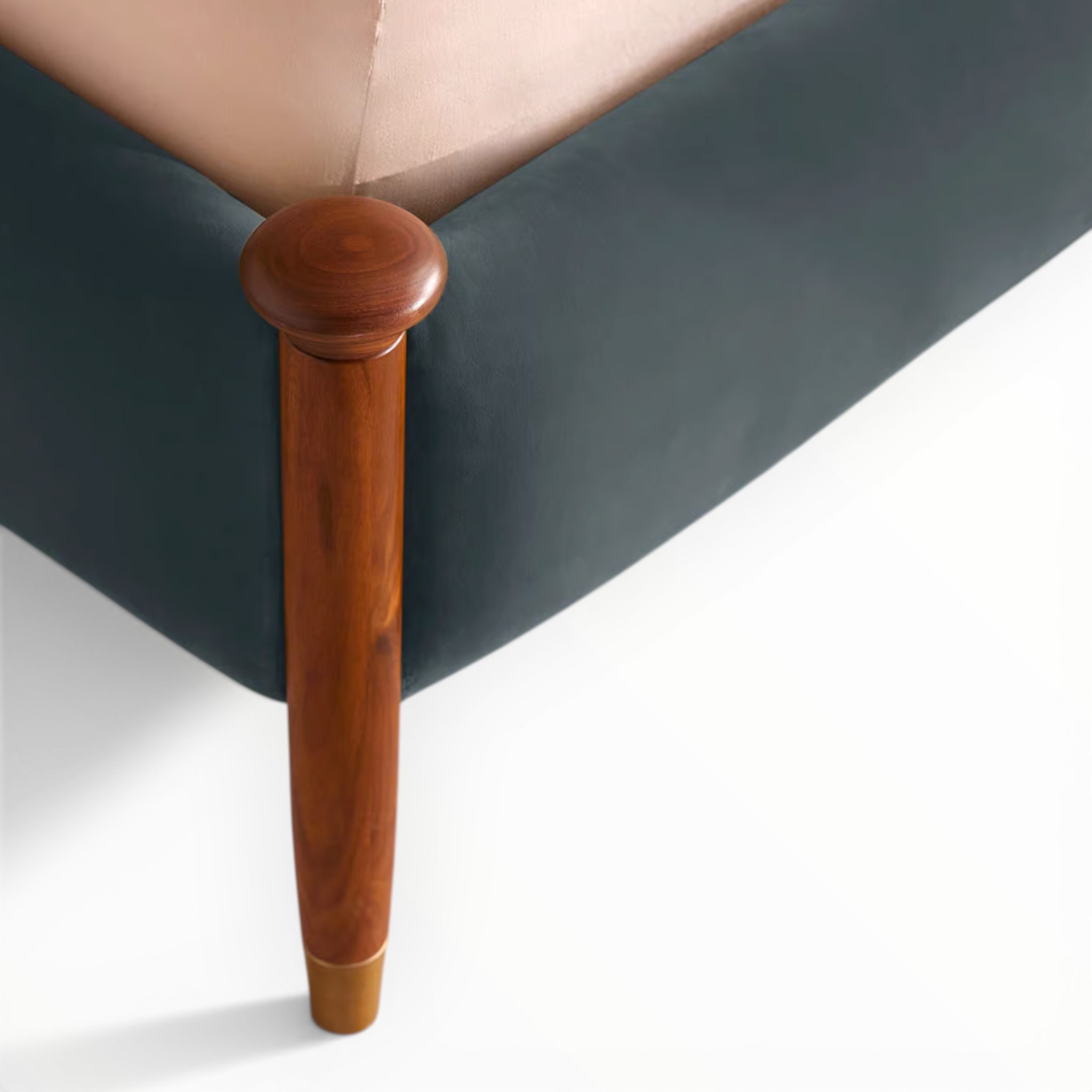 Close-up of a wooden leg on a piece of furniture with a white background