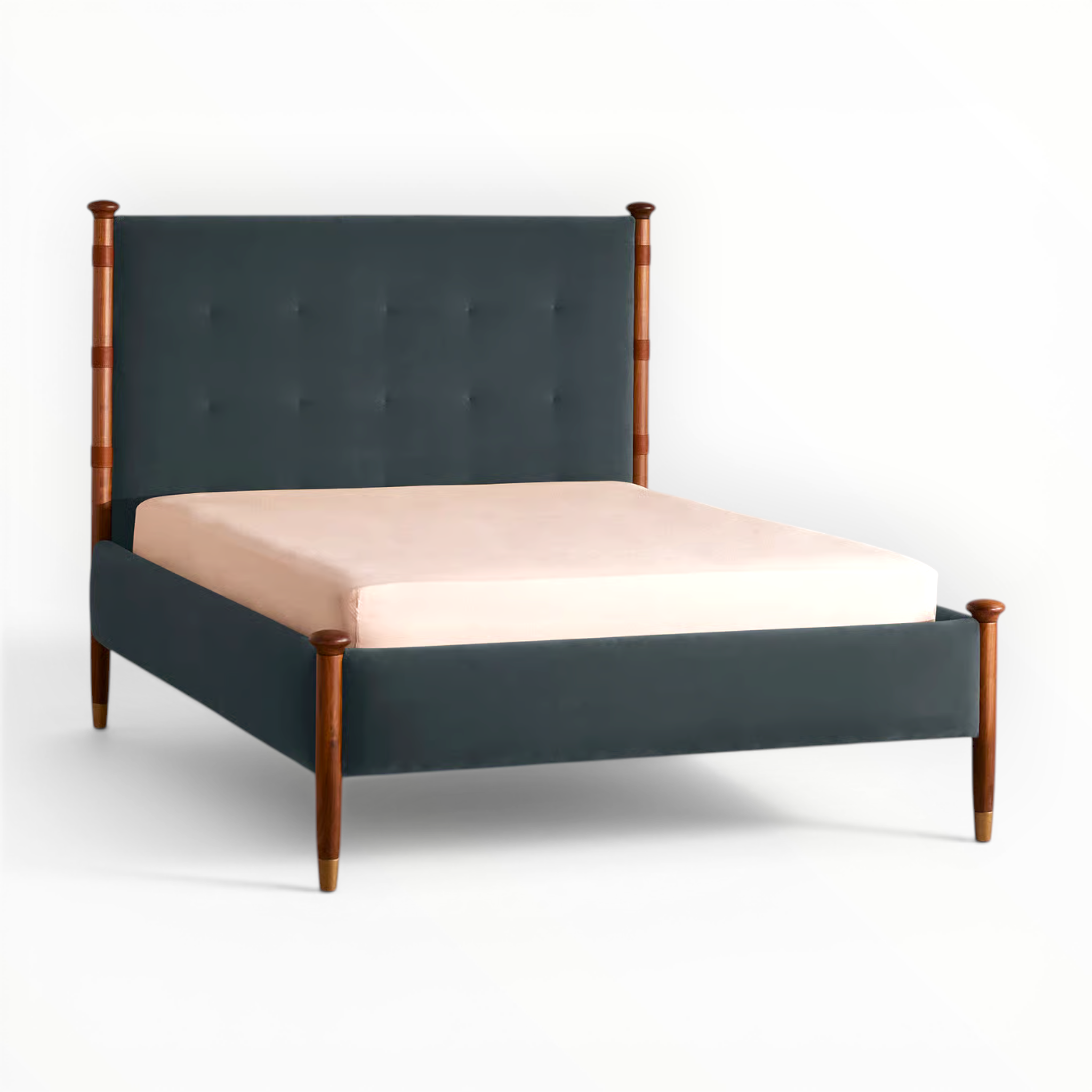 Bed with dark green upholstered headboard and wooden frame on a white background