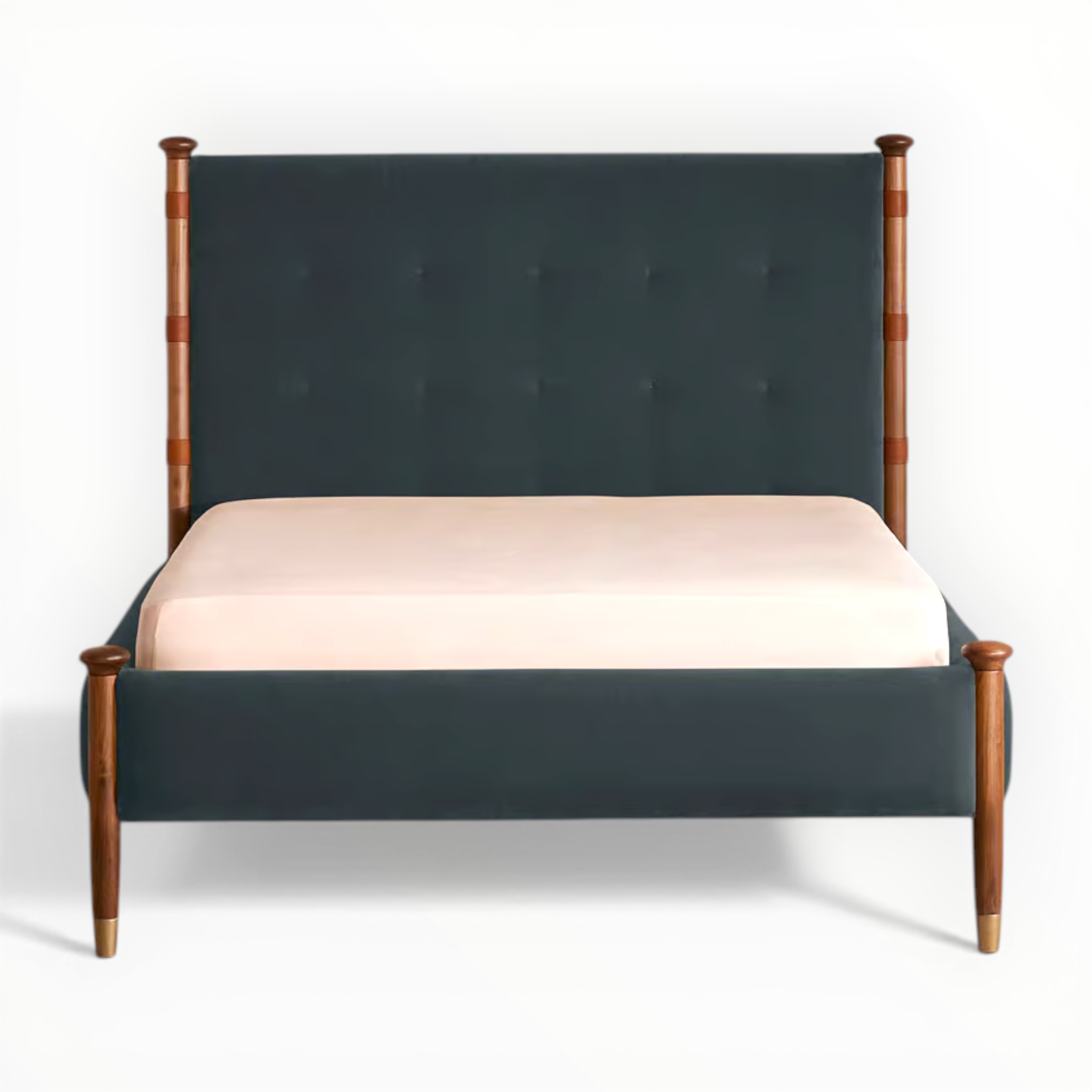 Bed with dark green upholstered headboard and wooden frame on a white background