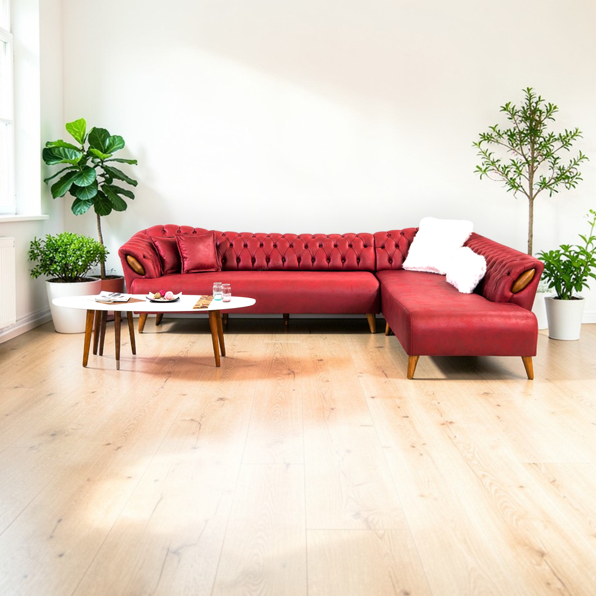 Red sectional sofa in a living room with plants and a coffee table.