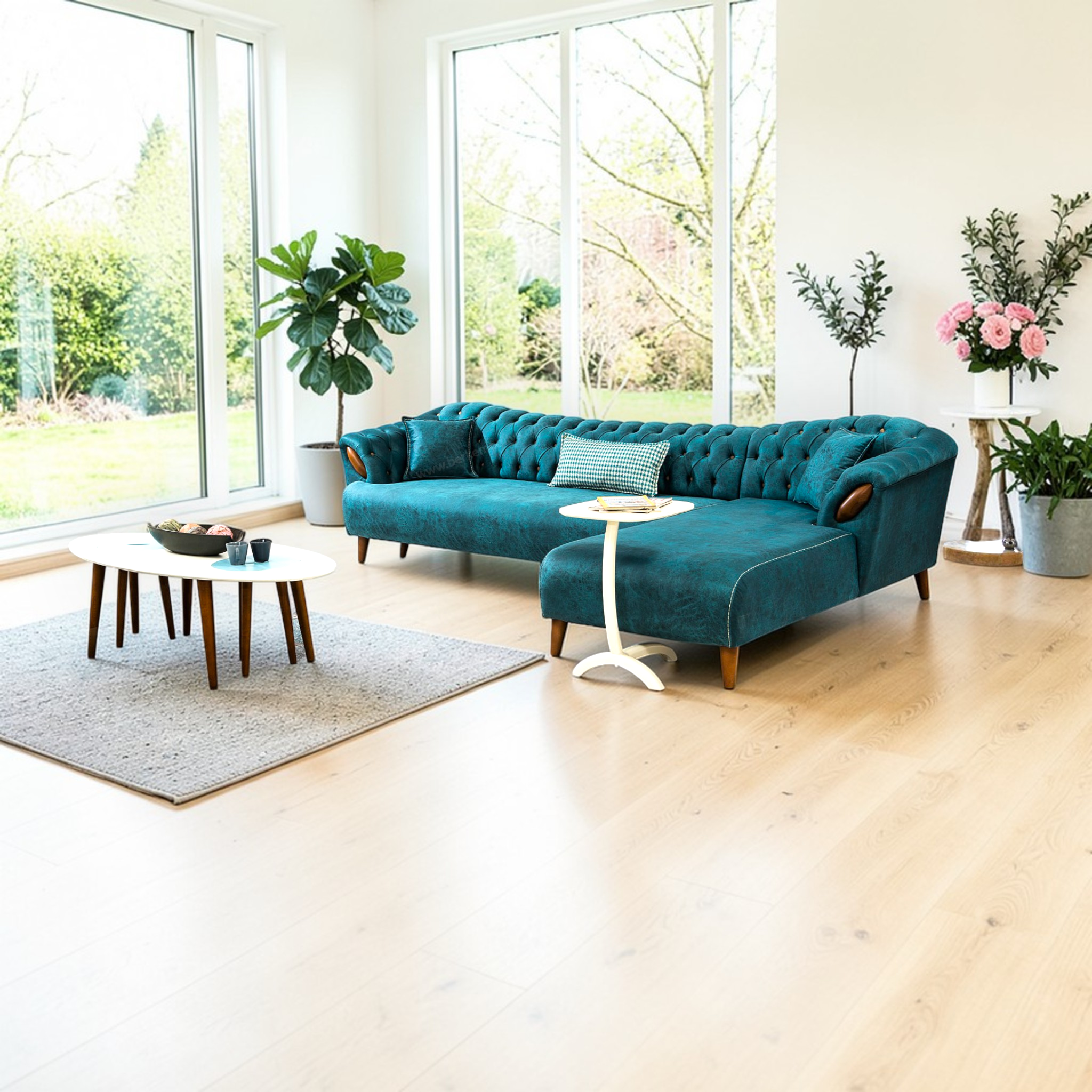 Modern living room with a teal sofa, coffee table, and decorative plants.