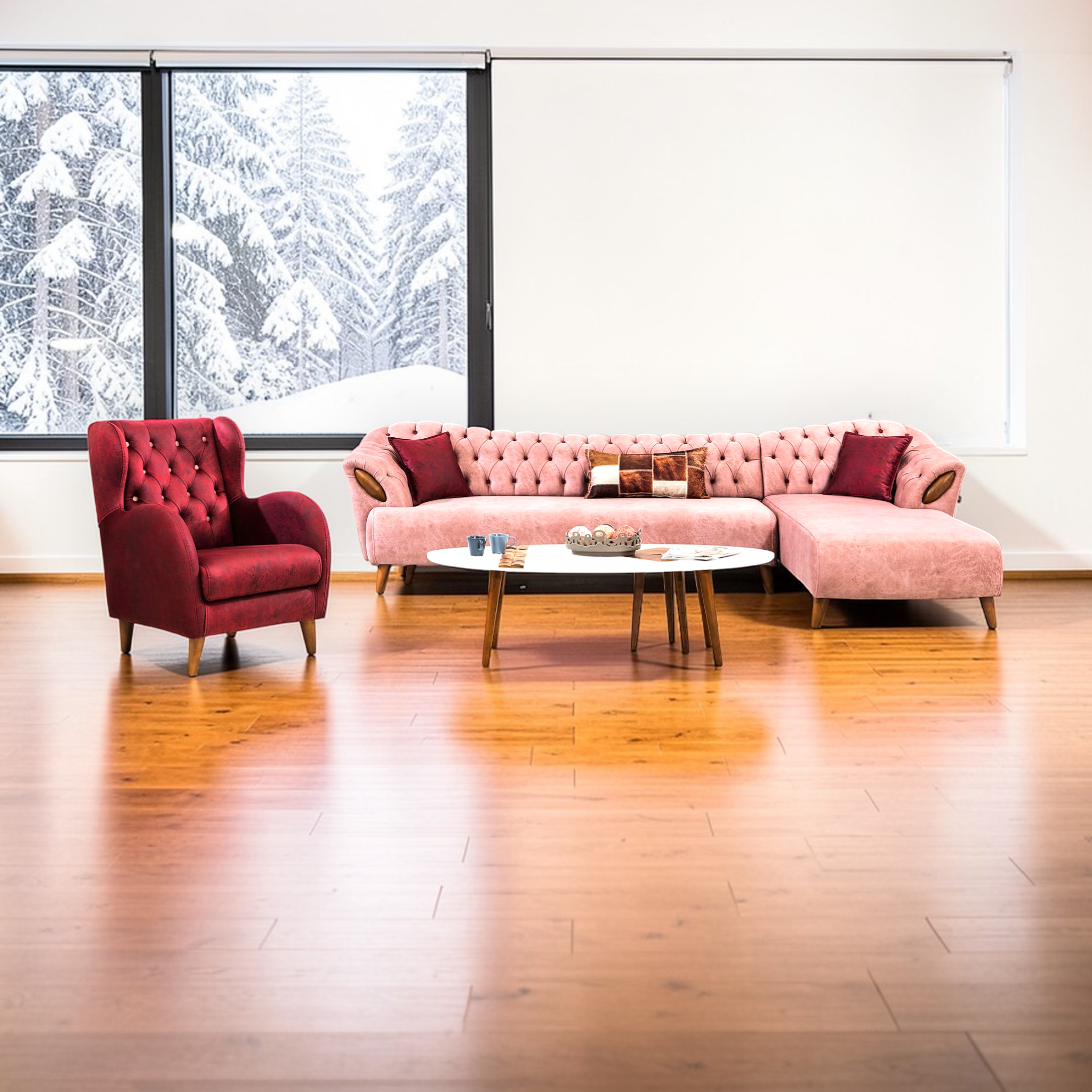 Living room with pink sofa and red armchair, large window showing snowy landscape.