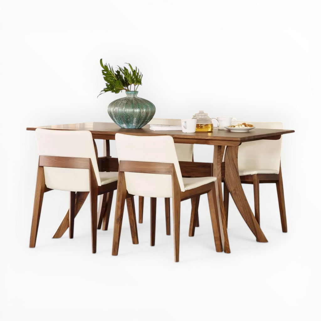 Dining table set with wooden chairs and a vase on a white background