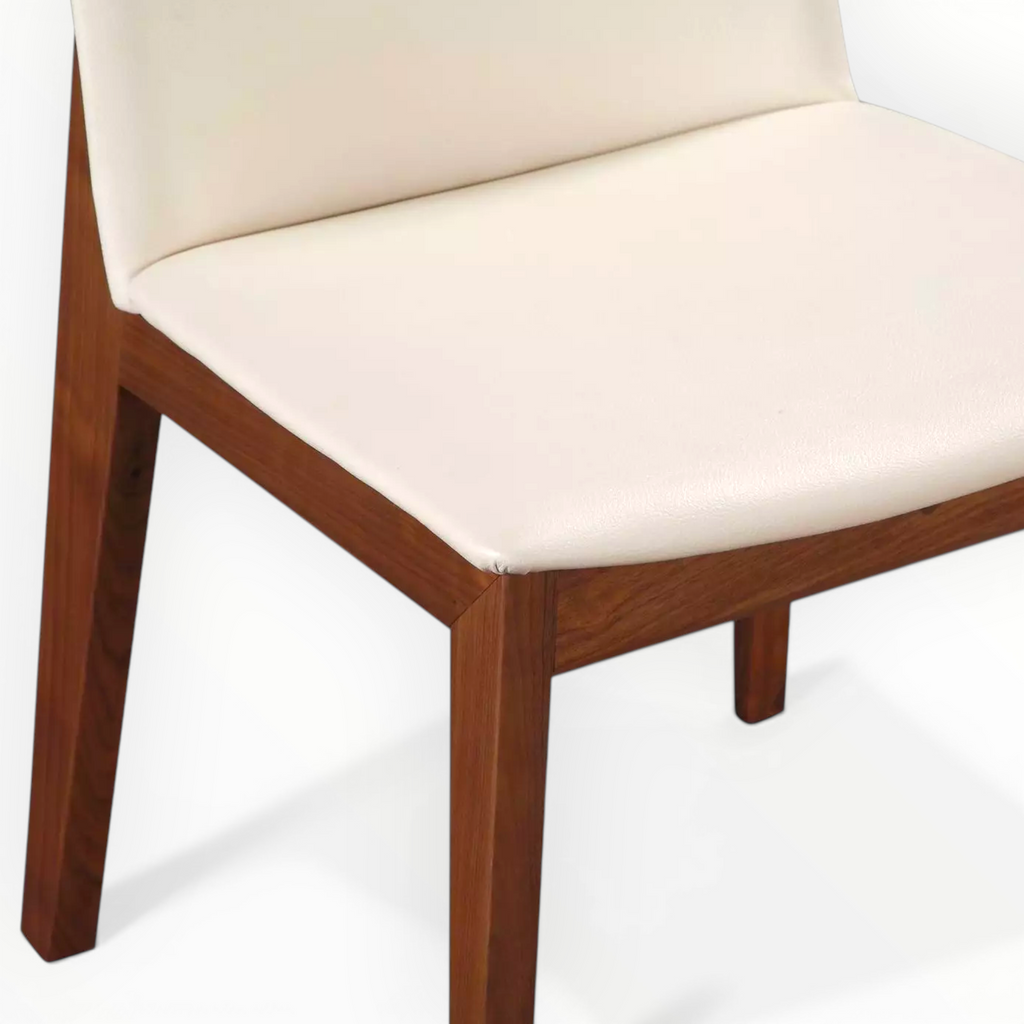 Wooden chair with a white cushion on a white background
