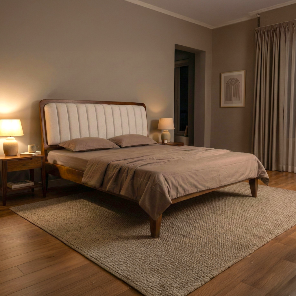 Bedroom with wooden bed, beige bedding, and lamps on nightstands.