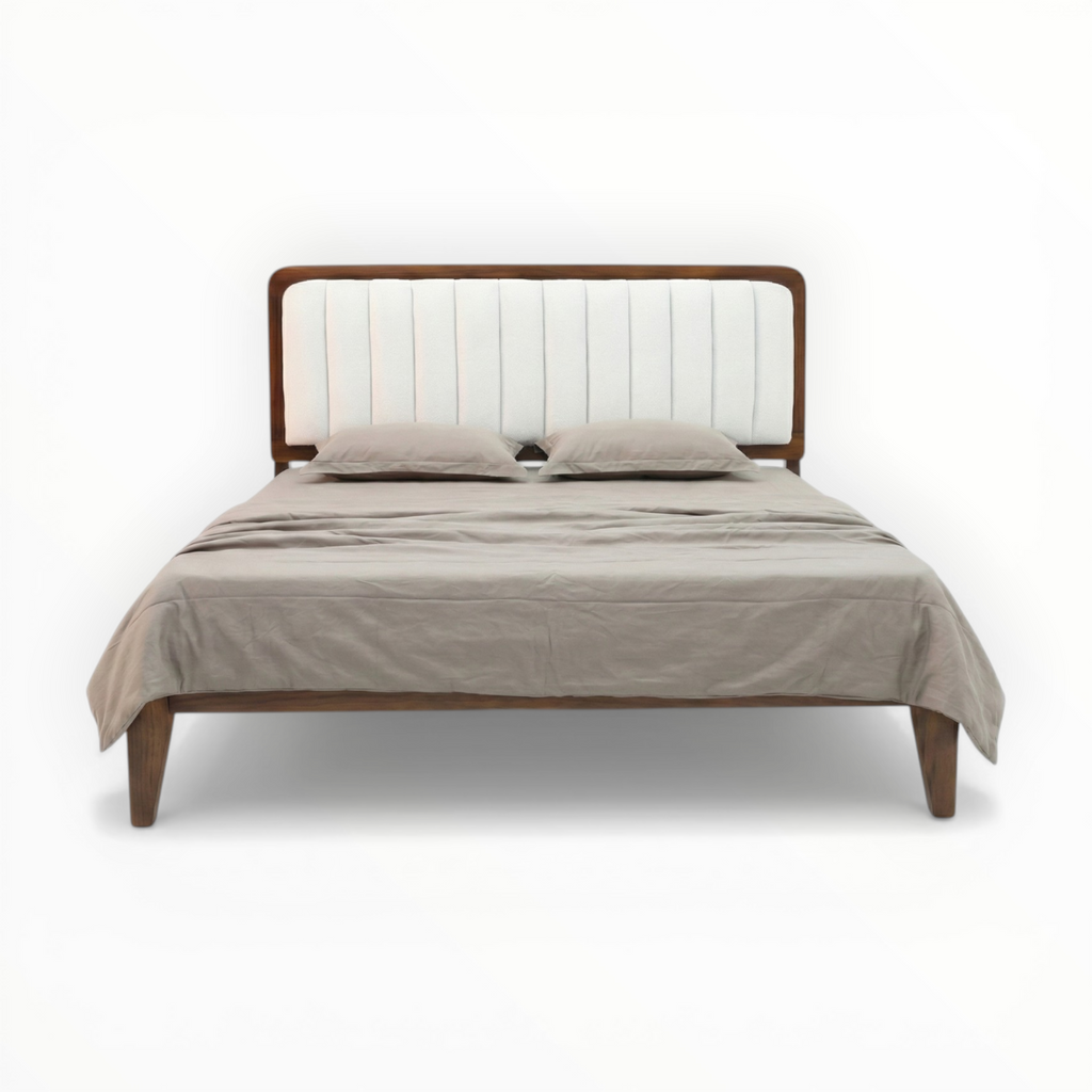 Bed with wooden frame and beige bedding on a white background