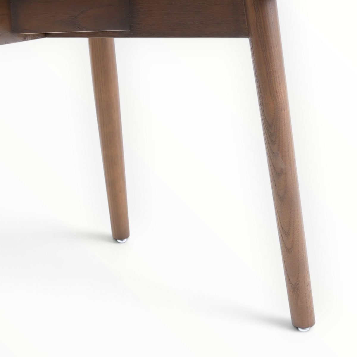 Emerald dining chair leg detail – solid teakwood tapered legs with metal floor gliders