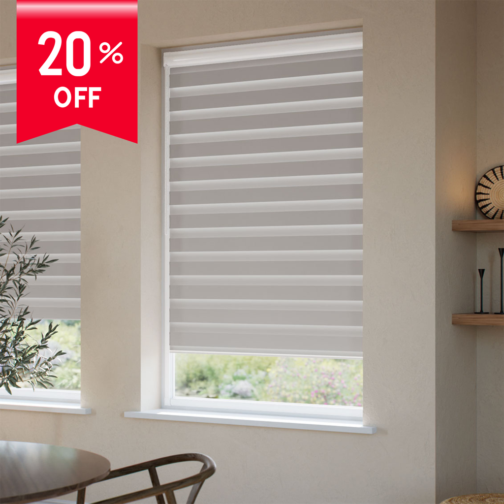 Window with blinds and a 20% off banner in a room with a table and plant.