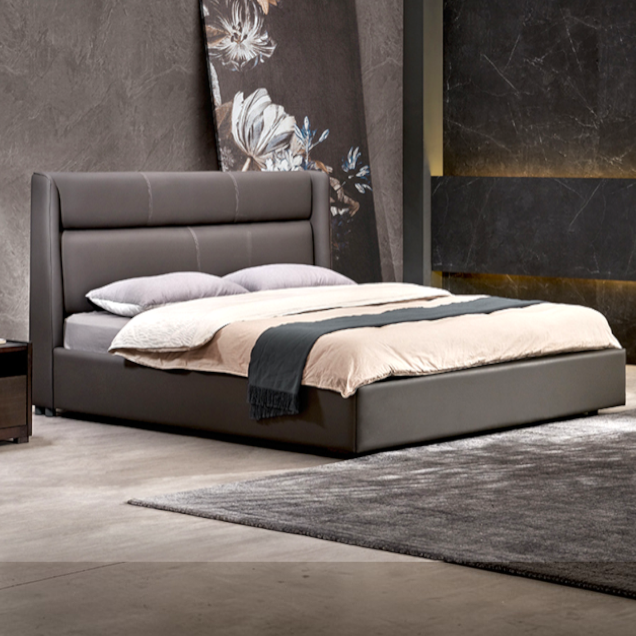 Gray upholstered bed with bedding in a bedroom setting