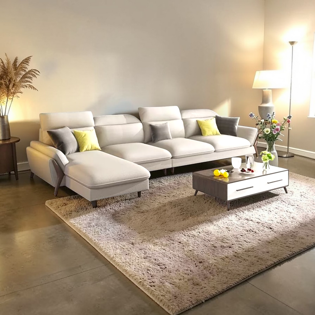 Modern living room with a white sectional sofa, coffee table, and decorative elements.